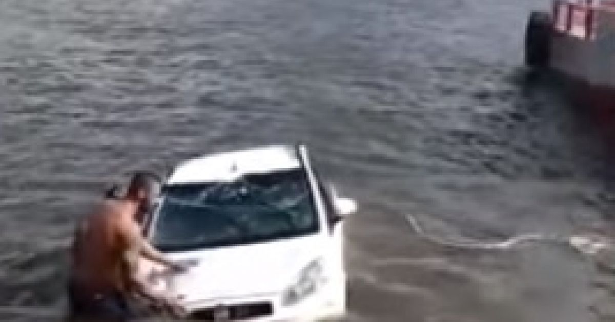 Carro com turistas desce rampa de balsas e vai parar dentro de rio